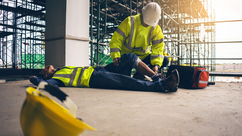 Worker aiding an injured employee on worksite