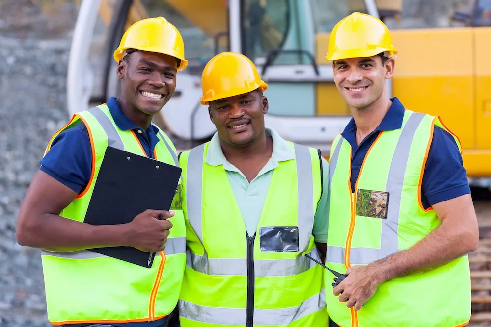 Three construction workers with yellow hardhats